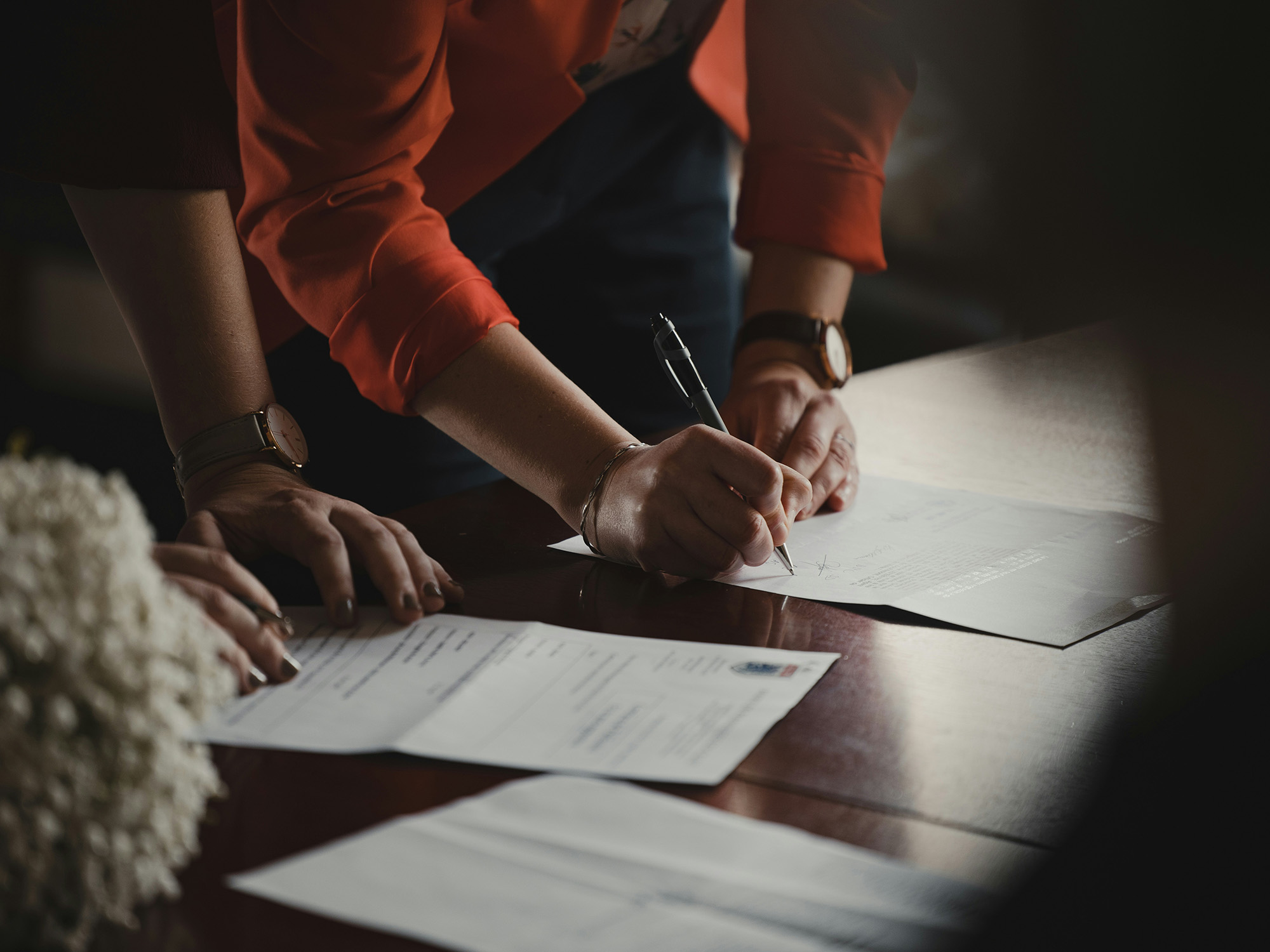 Two attorneys reviewing a client file together at a conference table